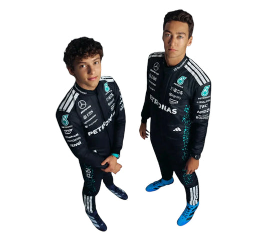 Two children wearing matching black racing suits with sponsor logos on a white background