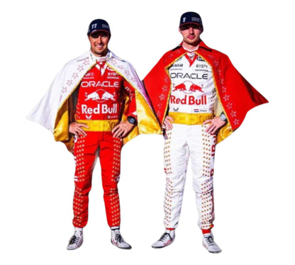 Two individuals wearing Red Bull racing suits with capes on a white background