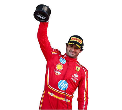 Person in a red racing suit with various sponsor logos, holding a trophy against a white background