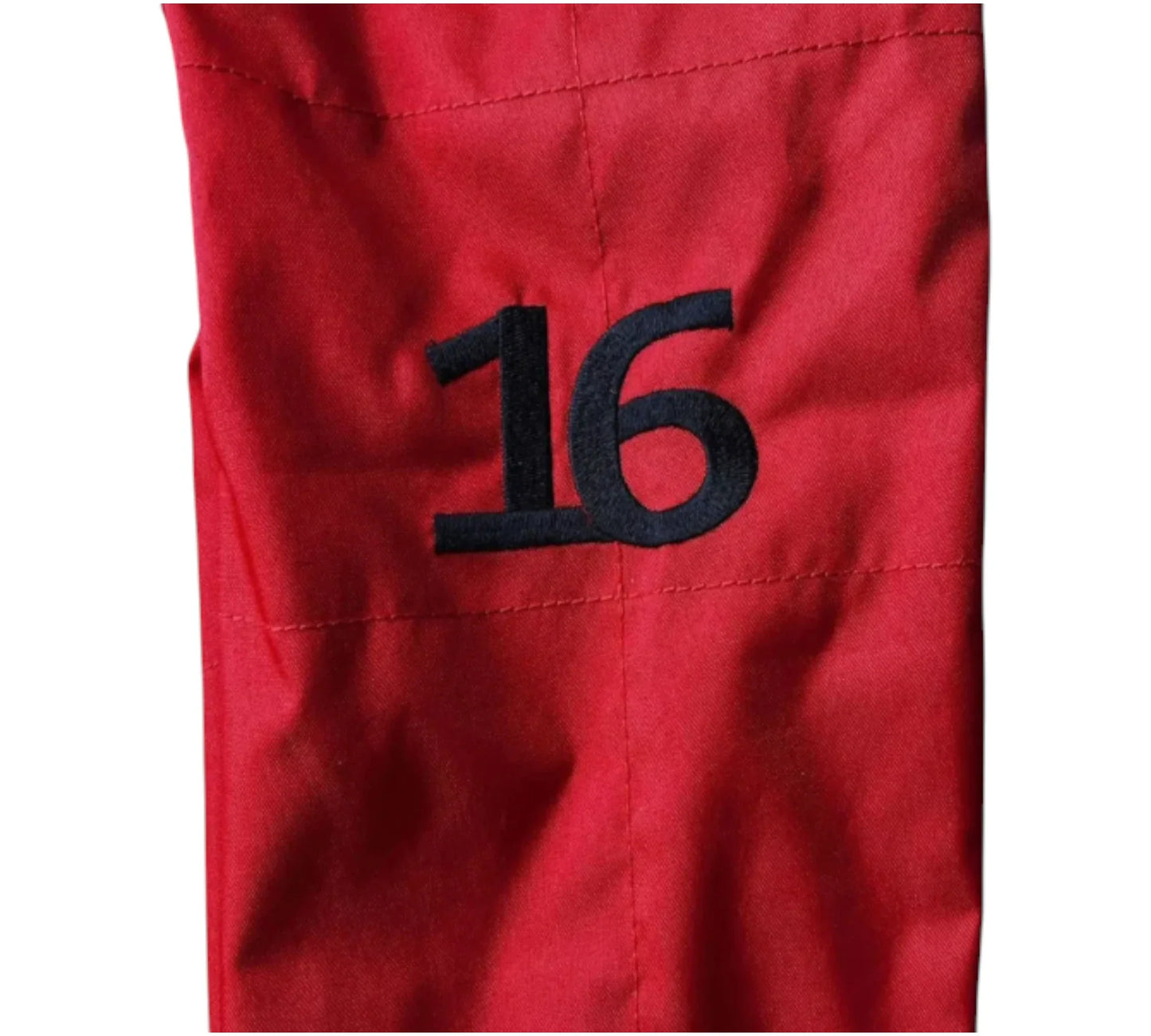 Red fabric with the number 16 embroidered in black on a white background
