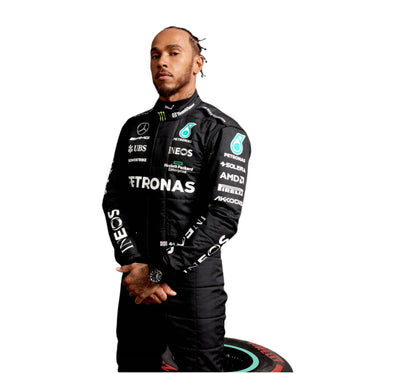 Person wearing a black racing suit with various sponsor logos on a white background