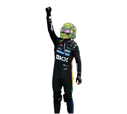Person in a racing suit and helmet with raised fist on a white background